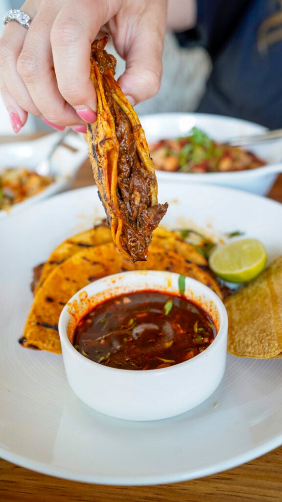 Woman dunking a taco at Toro Bravo in Reno.