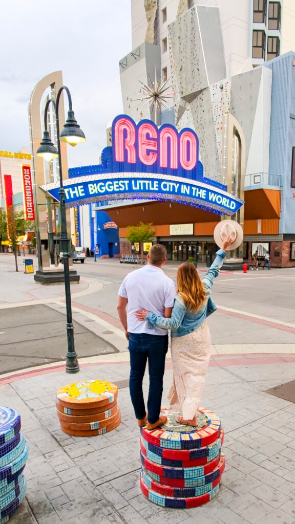 Couple under the Reno Nevada sign.