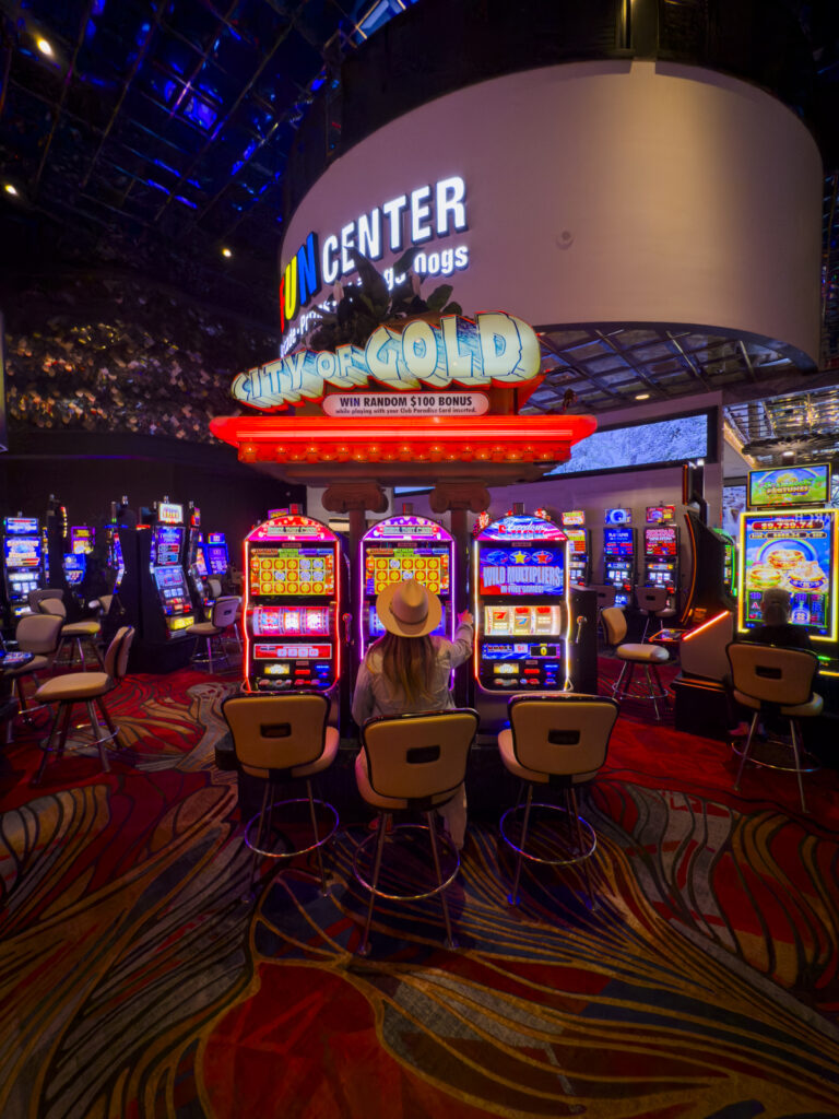 Woman gambling on a slot machine in Reno.