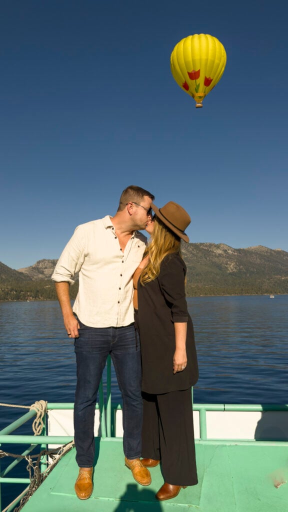 Couple kissing under a hot air balloon, one of the best things to do in Reno Tahoe for couples.