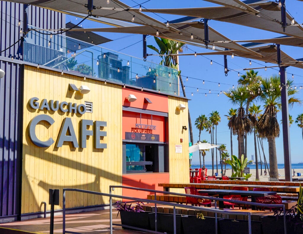 Couple with cocktails at Gaucho Beach rooftop in Long Beach, California.