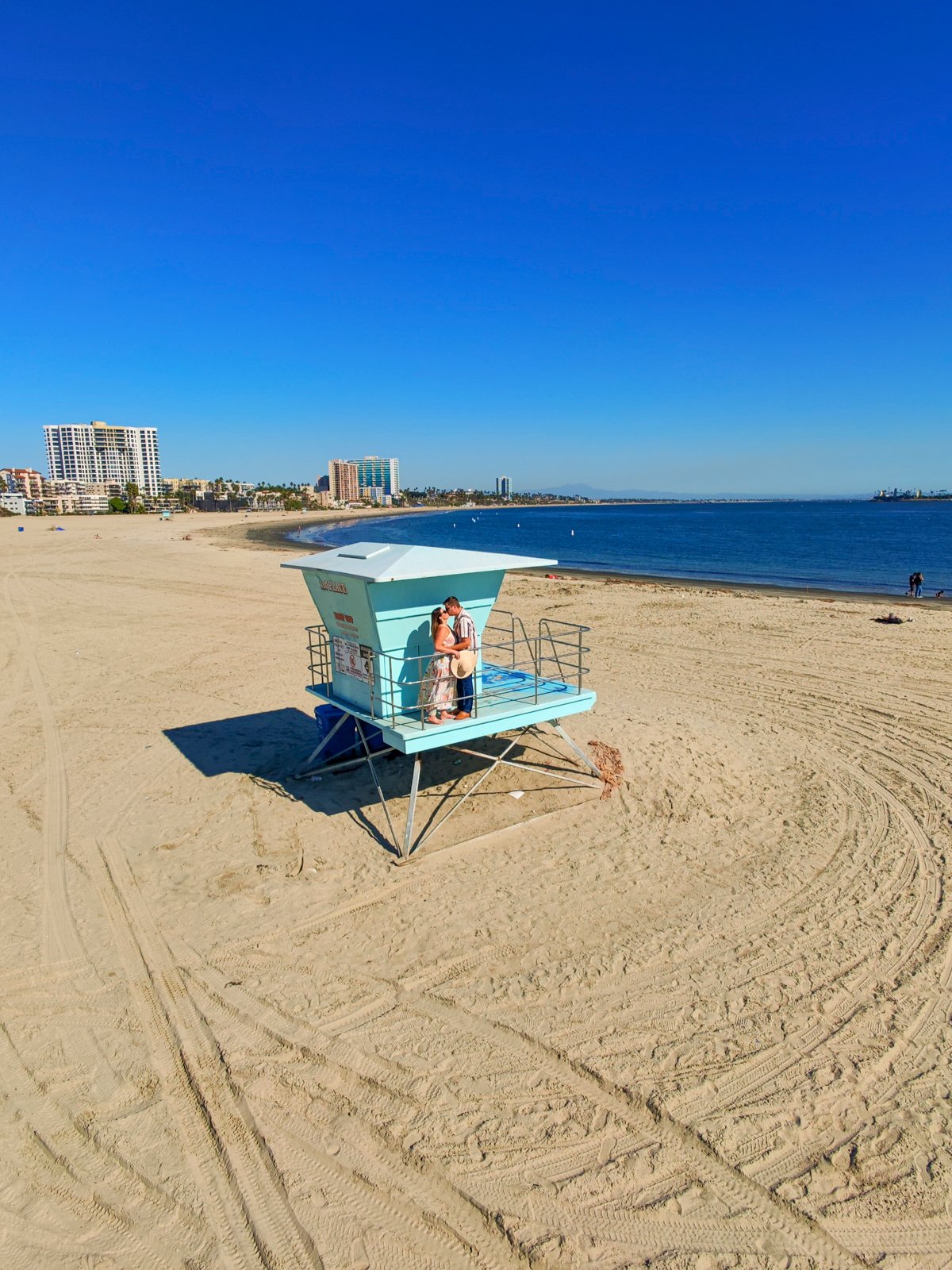 Couple on a lifeguard stand in Long Beach, California.