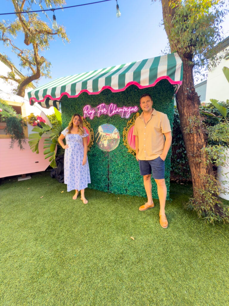 Couple in front of a Ring for Champagne wall in Long Beach, California.
