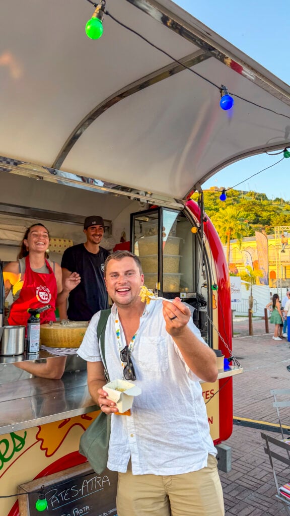 Man eating passionfruit pasta at the St. Martin Food Festival.