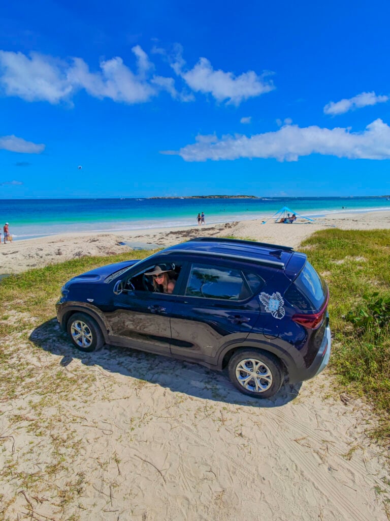 Woman with a car rental on a St. Martin beach.