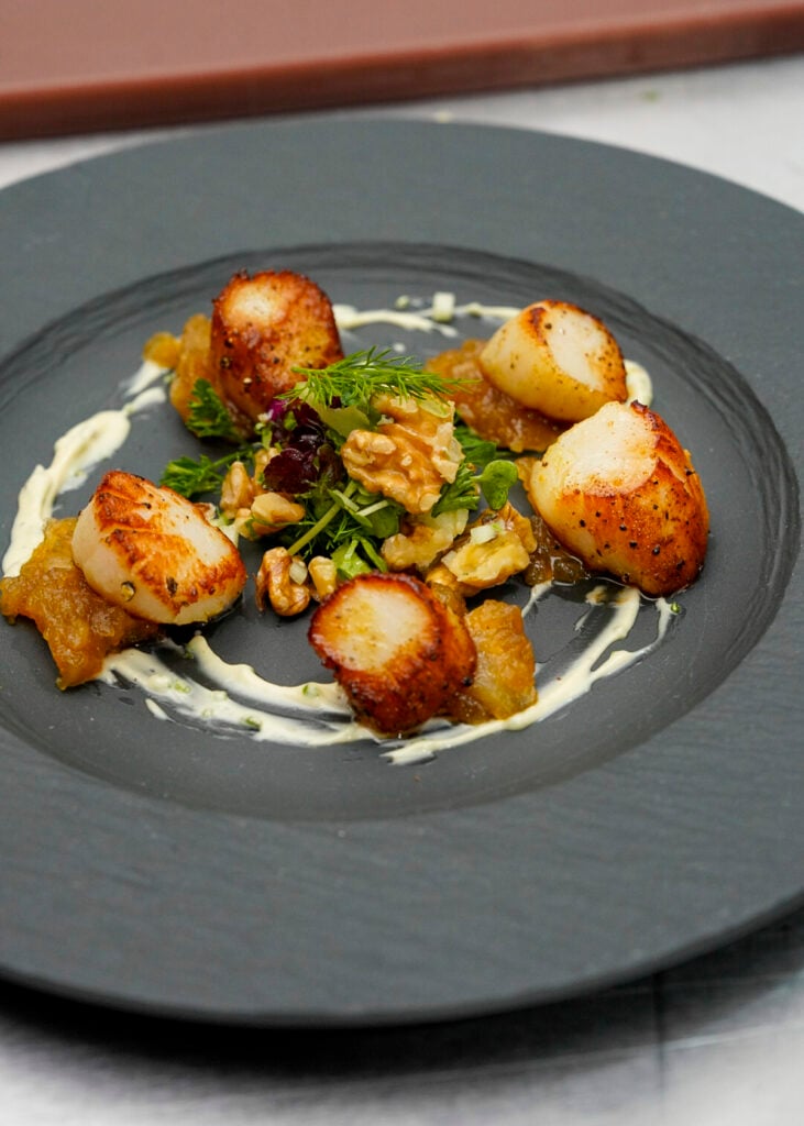 Plate of seared scallops at the St. Martin Food Festival.