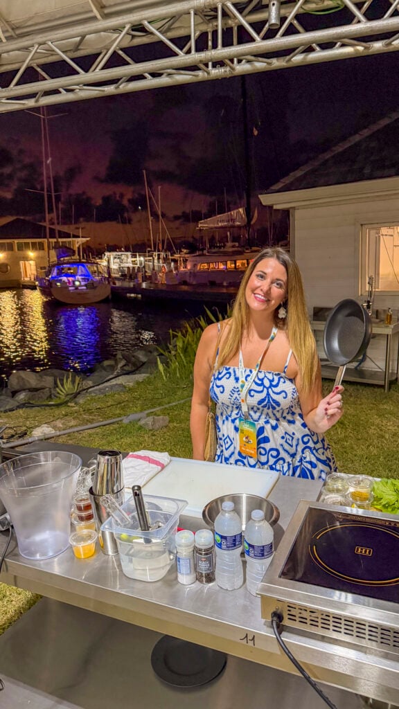 Woman with a pan at Sip N Cook at the St. Martin Food Festival.