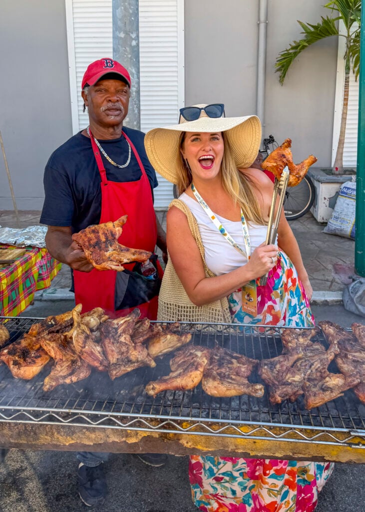 Woman with chicken at the St. Martin Food Festival BBQ Competition.