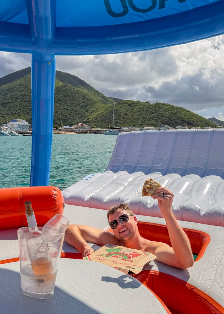 Man with pizza at Balaou, the floating restaurant in St. Martin.