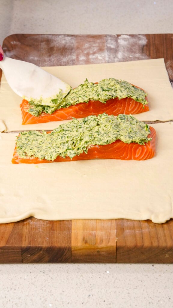 Salmon en Croute Salmon Wellington being topped with filling.