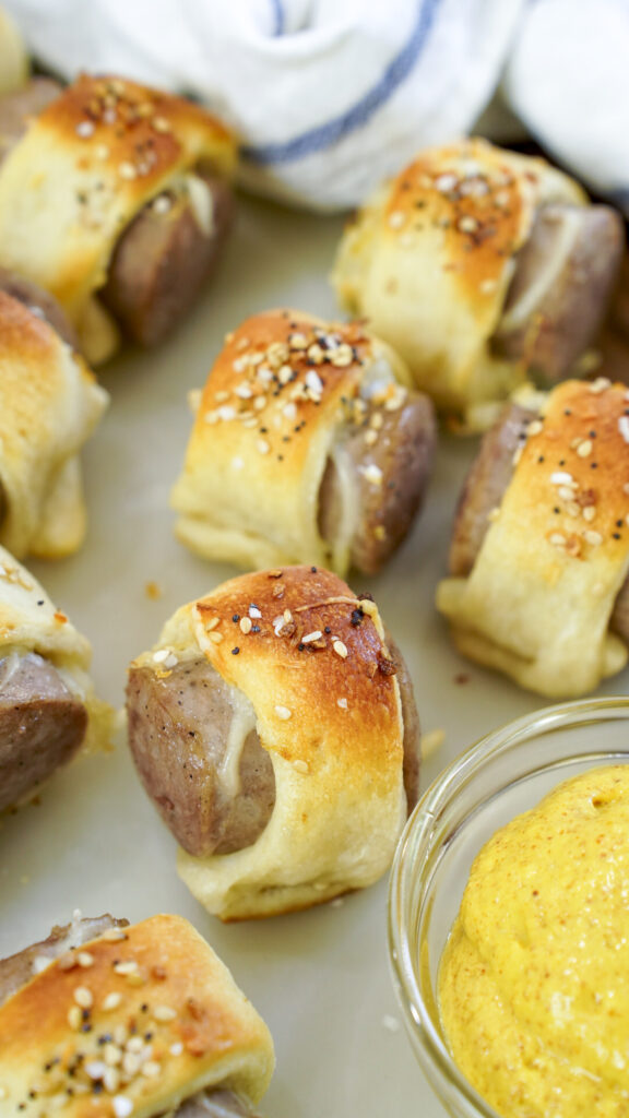 Brats in a blanket recipe for an oktoberfest party with mustard.