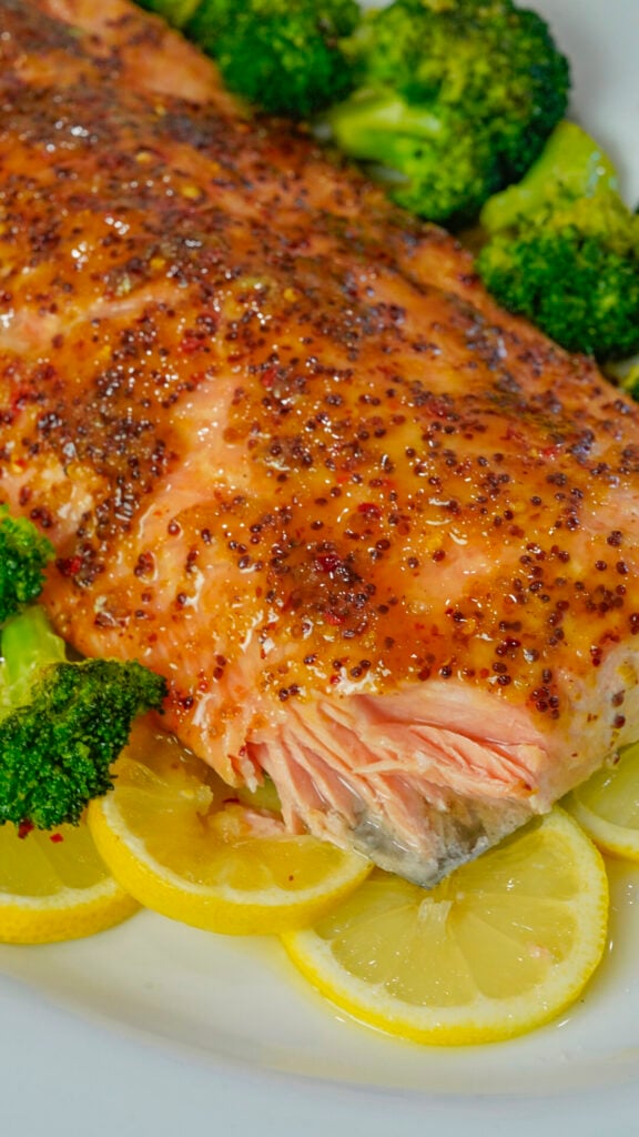 Honey mustard salmon recipe on a bed of lemon slices.