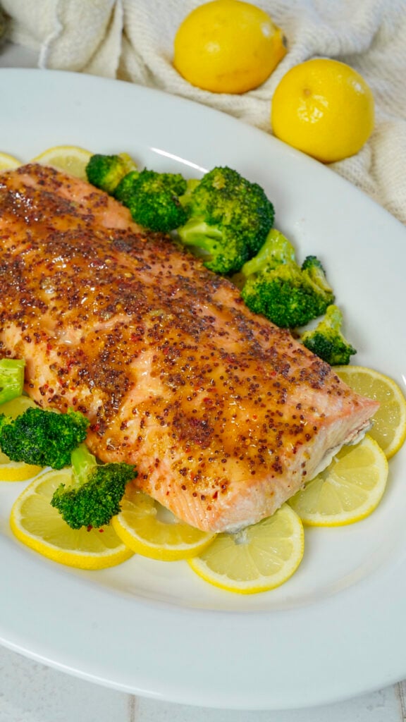 Honey mustard salmon recipe on a bed of lemon slices.