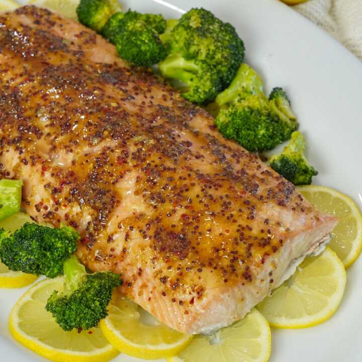 Honey mustard salmon recipe on a bed of lemon slices.