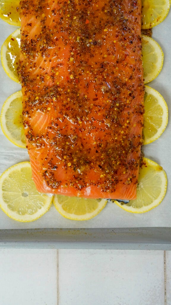 Honey mustard salmon recipe on a bed of lemon slices.