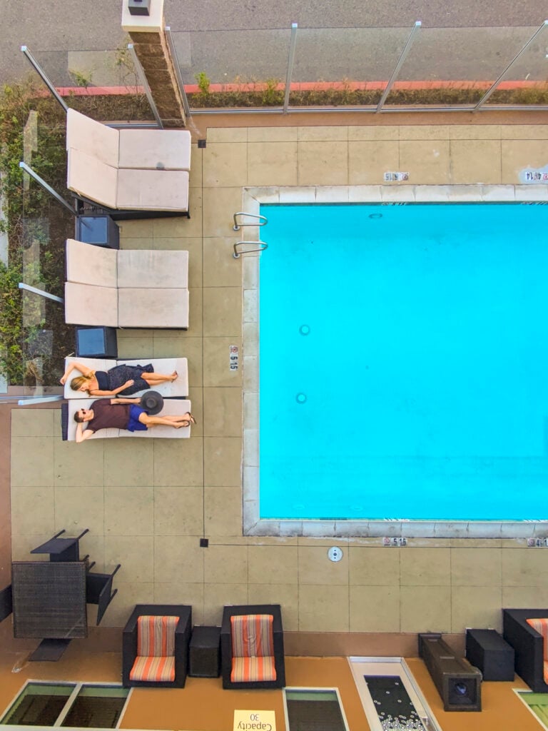 Couple lounging by a hotel pool in Buena Park.