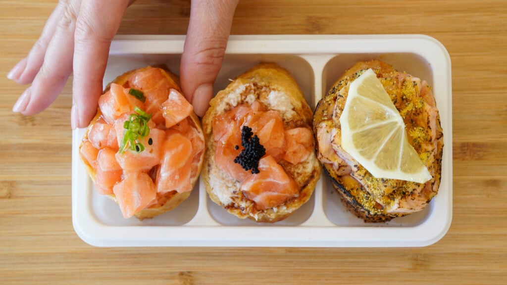 Woman holding sushi in Buena Park, CA.