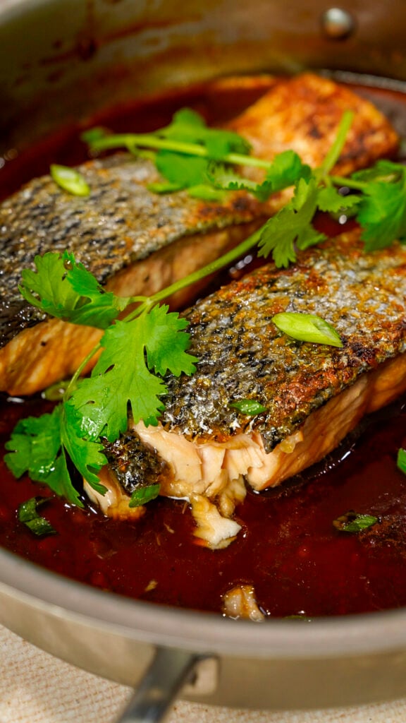 Vietnamese caramelized salmon recipe in a skillet with cilantro.