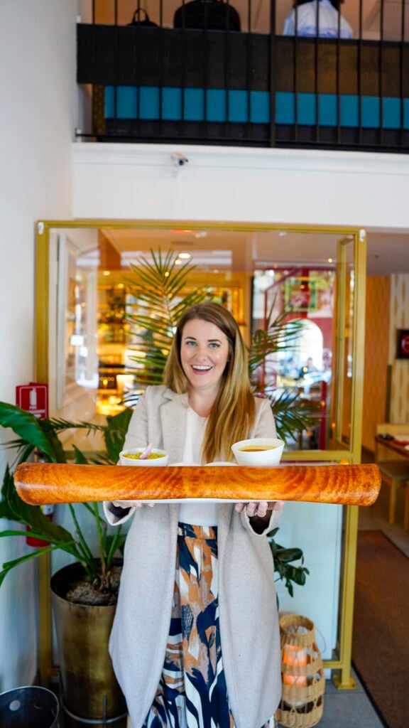 Woman with dosa from Rasa restaurant in the San Francisco Peninsula Flavors of the Peninsula event.