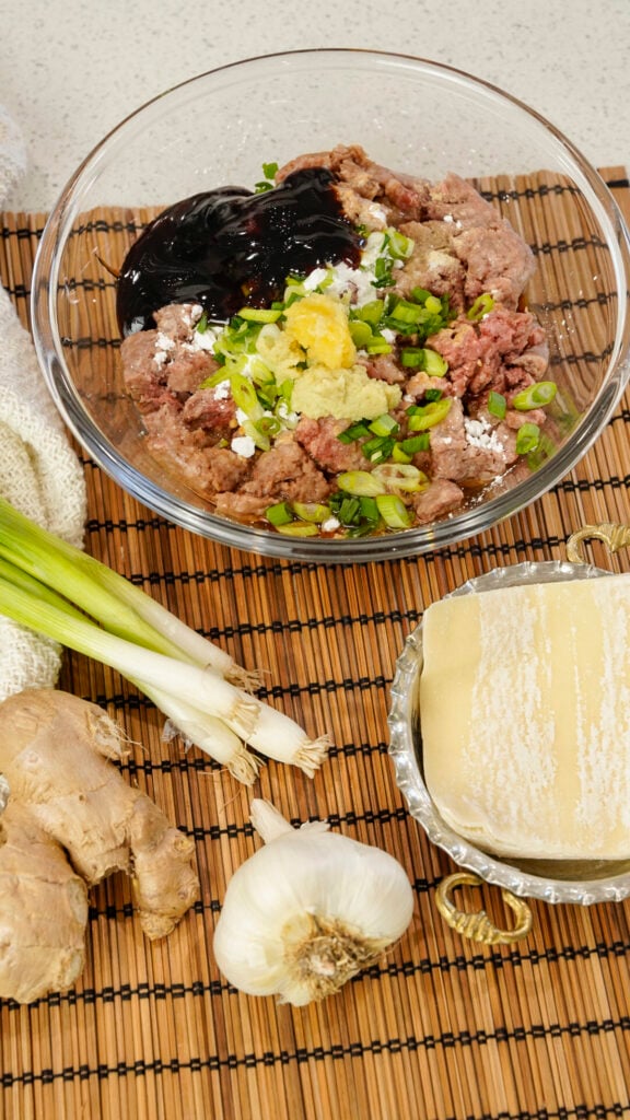 Ingredients for a Ground Beef Viral No Fold Blanket Dumpling Recipe in a bowl.