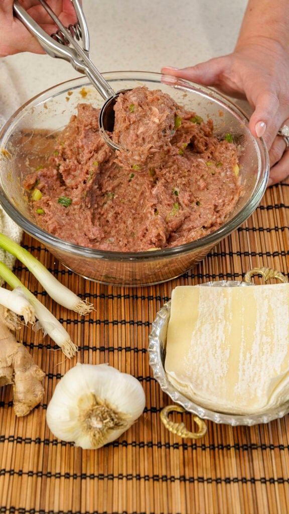Ingredients for a Ground Beef Viral No Fold Blanket Dumpling Recipe in a bowl.