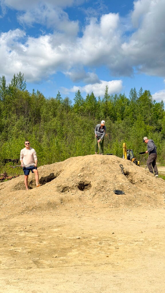 Man with pay dirt for panning for gold at Gold Daughters, one of the best things to do in Fairbanks Alaska in the summer.
