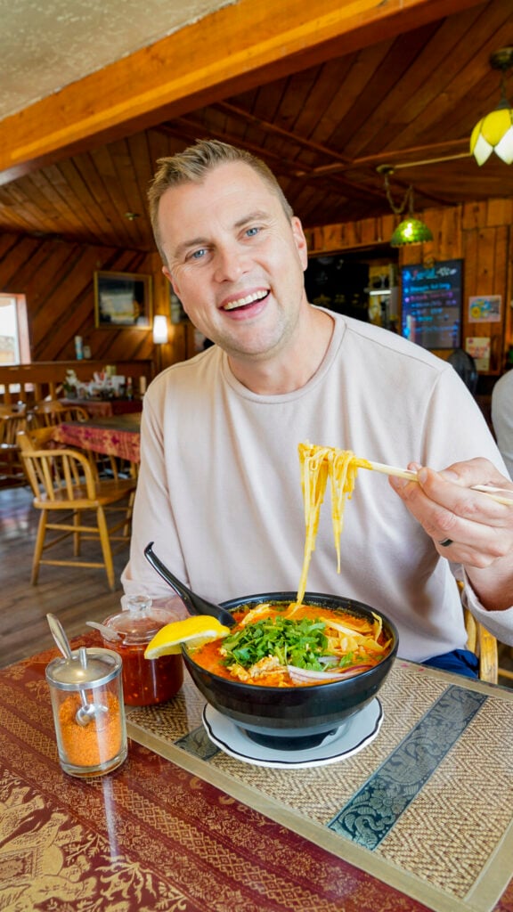 Man with noodles at one of the best Thai restaurants in Fairbanks Alaska.