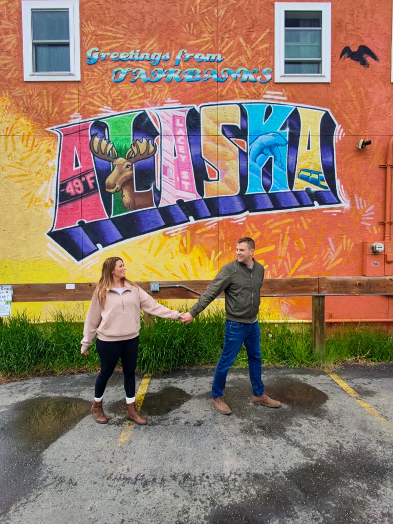 Couple in front of the Fairbanks Alaska mural, one of the best things to do in Fairbanks Alaska in the summer.
