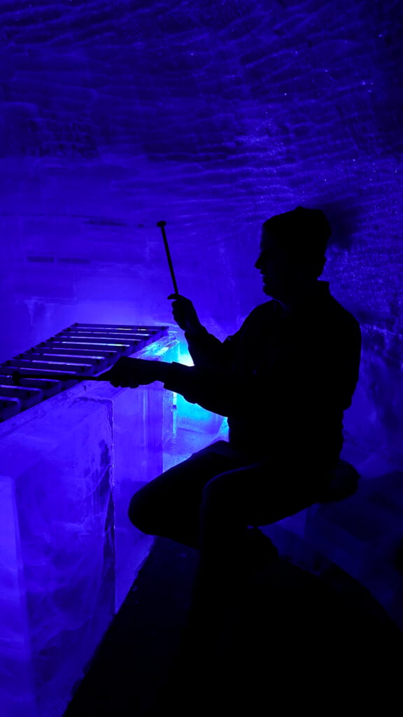 Man playing music inside Aurora Ice Bar at the the Chena Hot Springs in Fairbanks Alaska in summer.