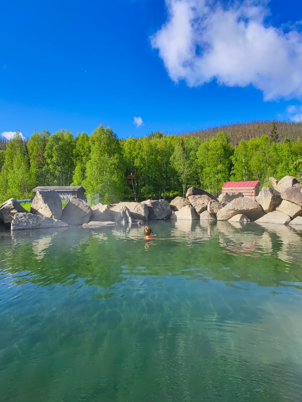 Woman relaxing at the Chena Hot Springs in Fairbanks Alaska in summer.