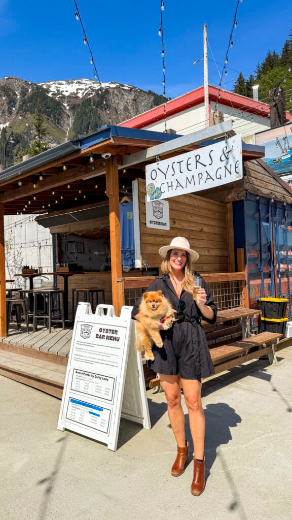 Woman with a dog at a Juneau oyster stand - Things to do in Juneau Alaska from a cruise ship
