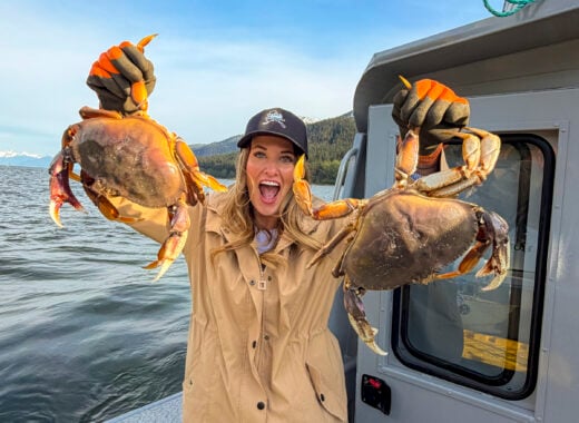 Woman holding crabs from the Into Alaska crabbing tour in Juneau, Alaska.