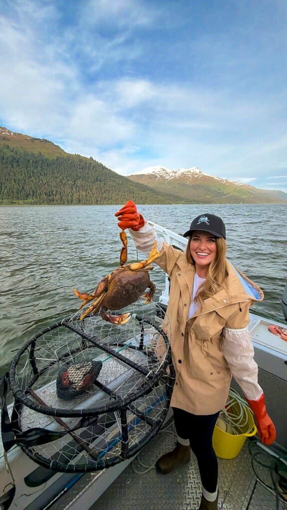 Woman holding crabs from the Into Alaska crabbing tour in Juneau, Alaska.