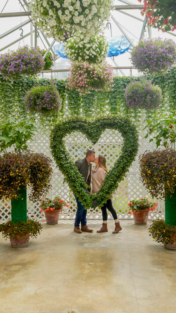 Couple at a heart topiary in Glacier Gardens - Things to do in Juneau Alaska from a cruise ship