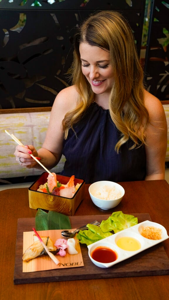Woman eating a dish from Nobu at Miami Spice.